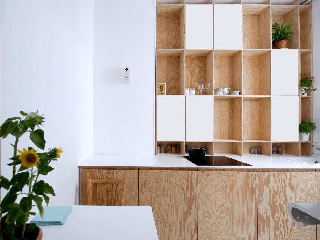 A kitchen with a sink and a mirror